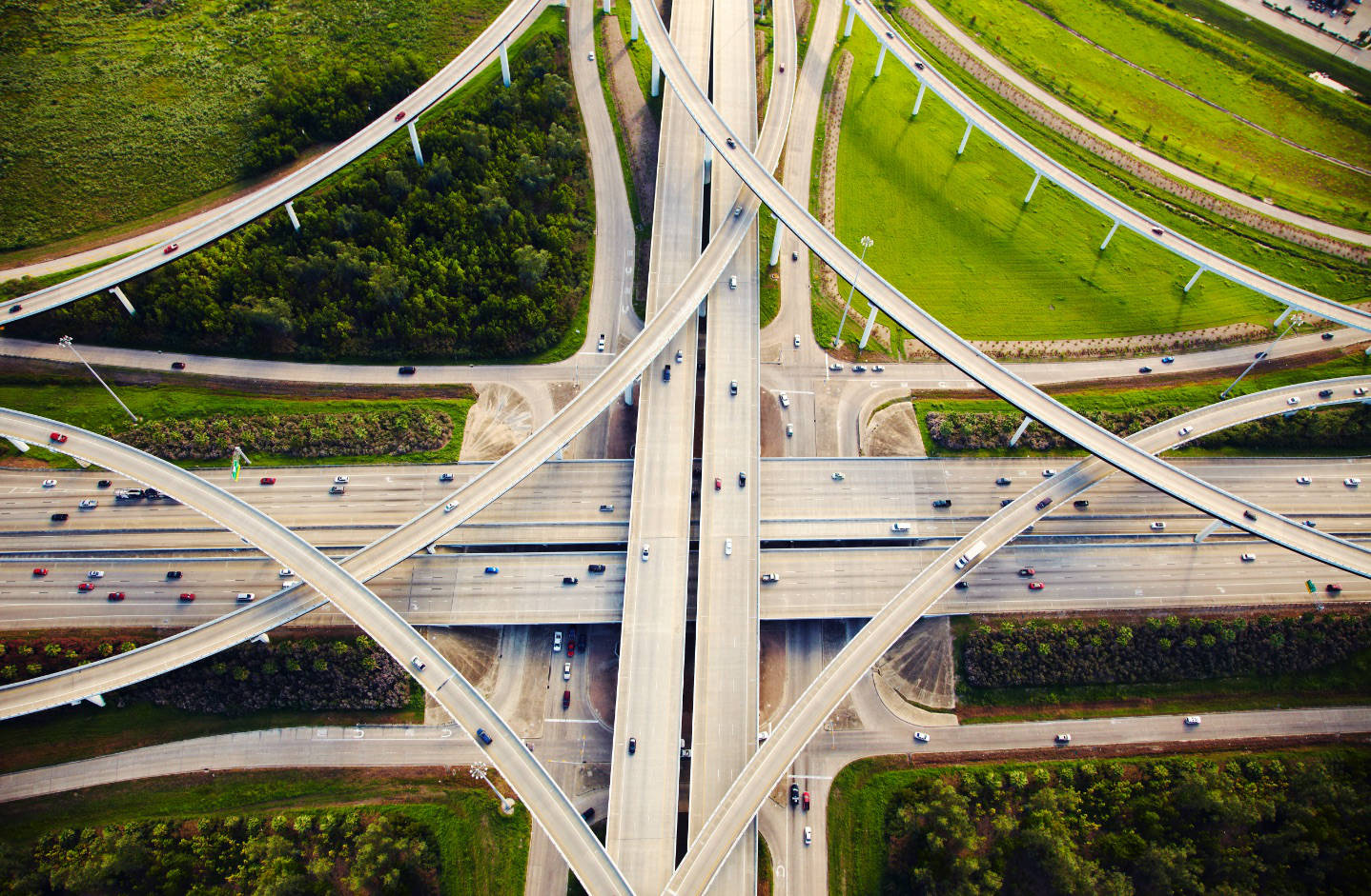 Aerial view of multiple highways crisscrossing each other andcars driving on them